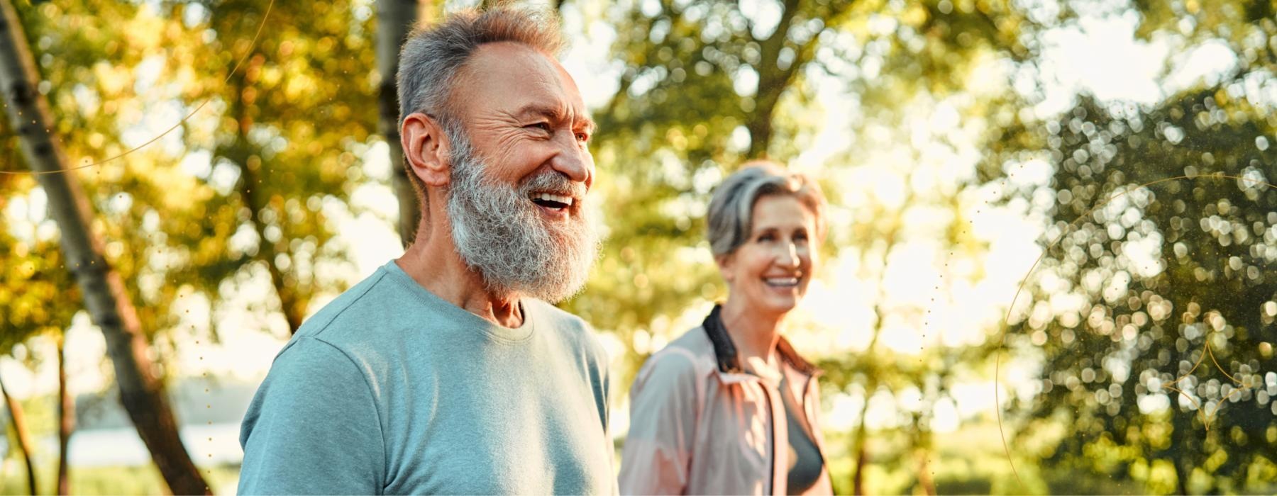 a man and a woman smiling and walking through park  Mount Holly NJ luxury apartments for rent J Centra Burlington 