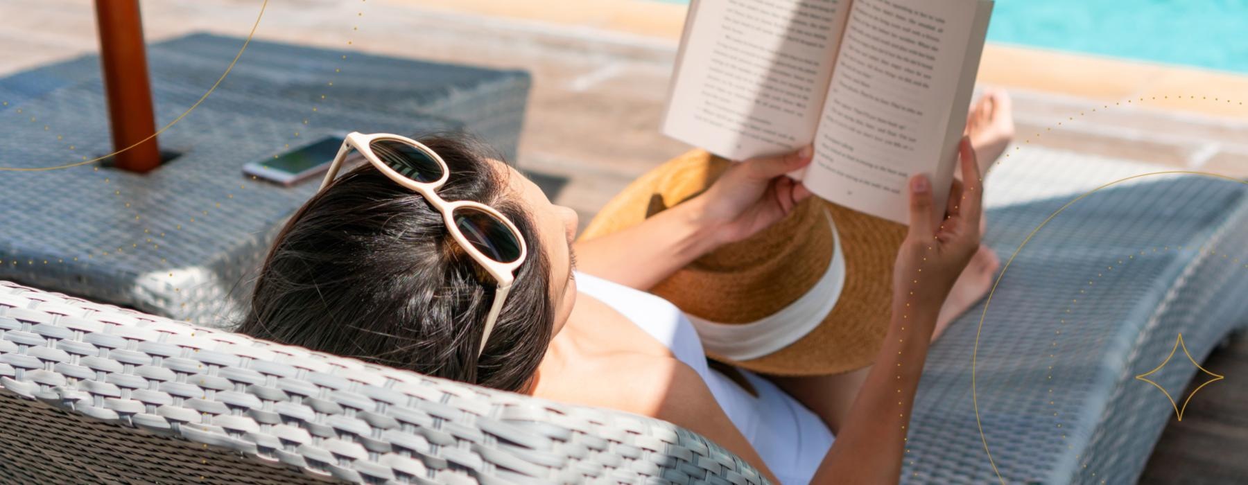 a person lying near a pool with a book and sunglasses on  Mount Holly NJ apts for rent J Centra Burlington 